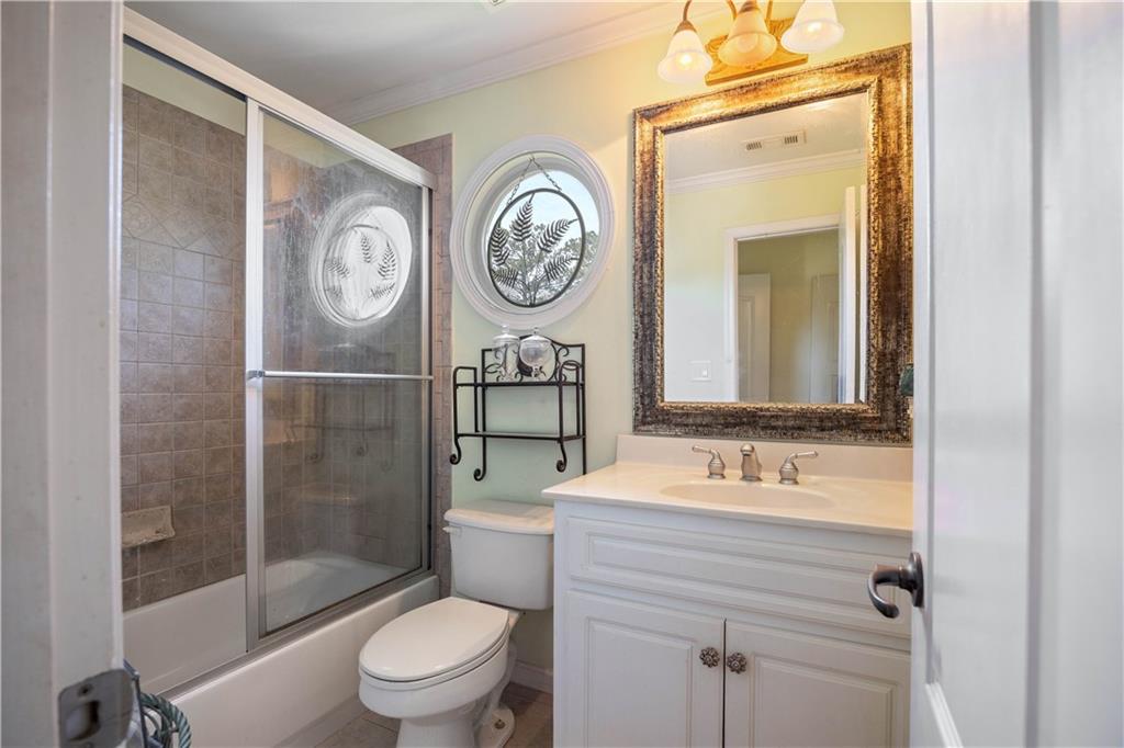 802 Pathview Court Dacula, GA 30019 - Photo 21 of 50 a bathroom with a granite countertop toilet a sink and a mirror