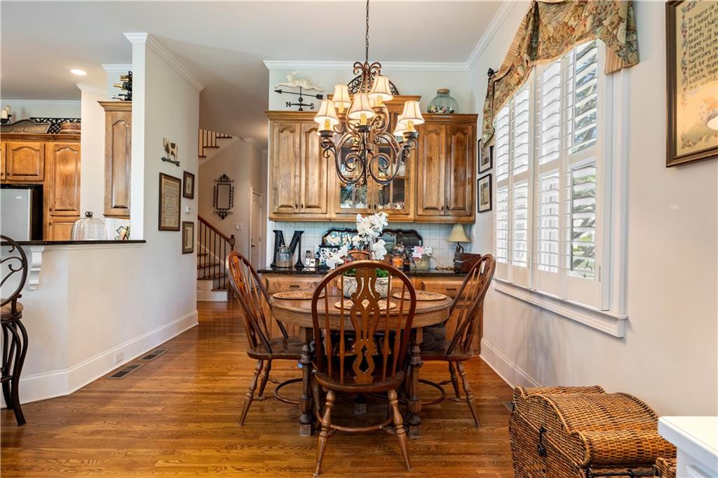 802 Pathview Court Dacula, GA 30019 - Photo 42 of 50 a view of a dining room with furniture and chandelier