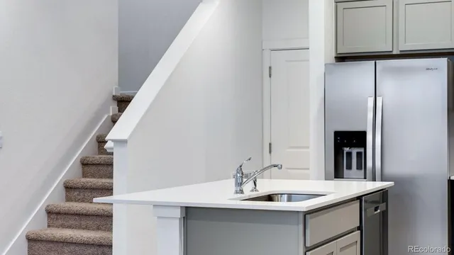 a dining room with wooden floor and white cabinets