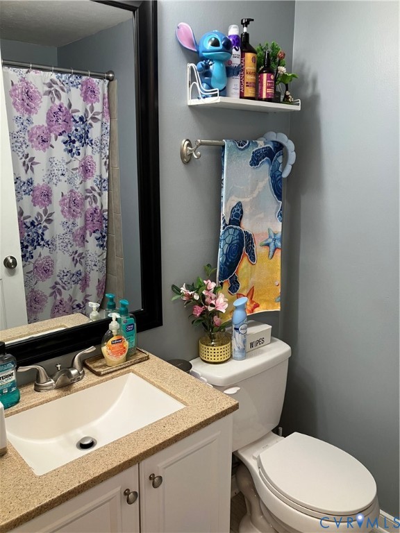 7608 Portadown Court, Unit 2602 Henrico, VA 23228 - Photo 32 of 37 a bathroom with a sink mirror vanity and toilet