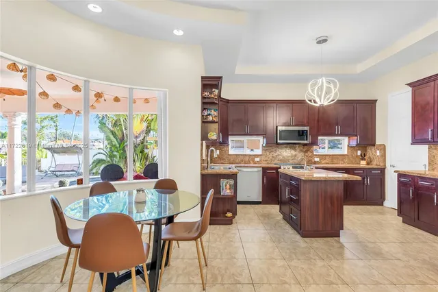 a kitchen with a sink stove top oven and microwave