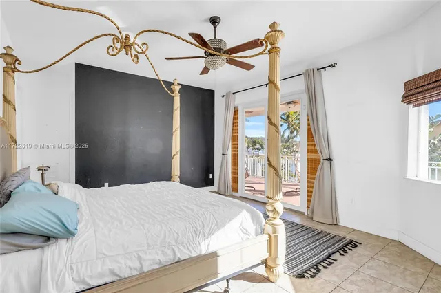 a spacious bathroom with a double vanity sink a large mirror a bathtub and next to a window