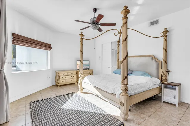a spacious bathroom with a granite countertop sink a toilet and bathtub