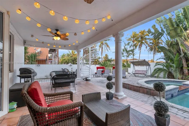 a view of a patio with table and chairs and potted plants