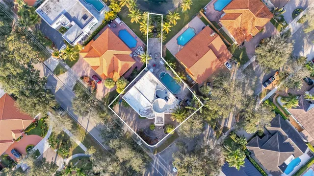 an aerial view of residential houses with outdoor space and lake view