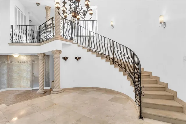 a very nice looking room with a large window and chandelier
