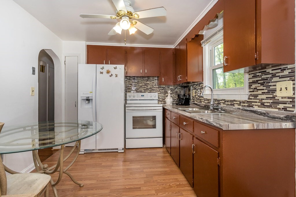 1 Desmond Road Randolph, MA 02368 - Photo 9 of 18 a kitchen with stainless steel appliances granite countertop a stove and a refrigerator