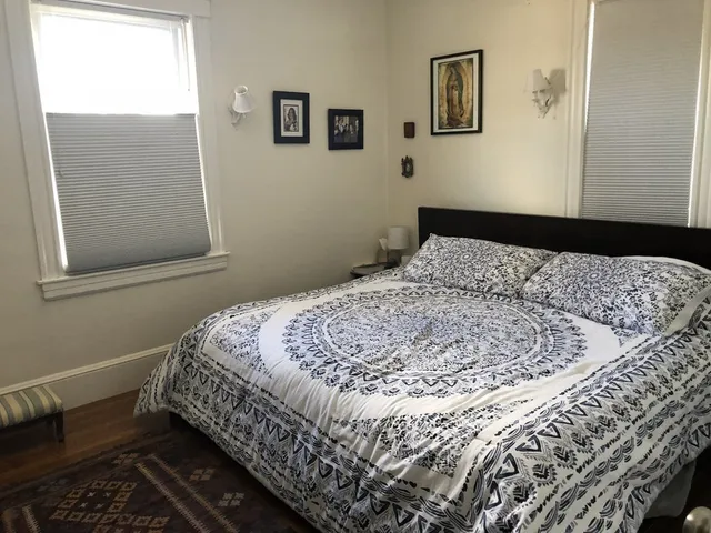 a bedroom with a bed and a window