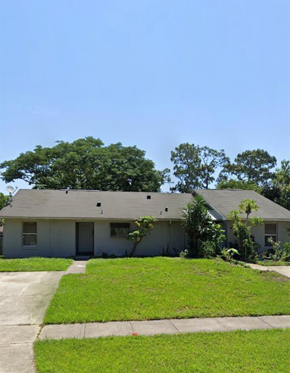 1215 Ravida Circle Orlando, FL 32825 - Photo 1 of 1 a front view of a house with a yard and garage