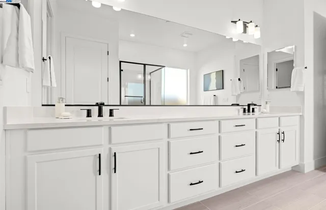 a bathroom with double sink and a mirror