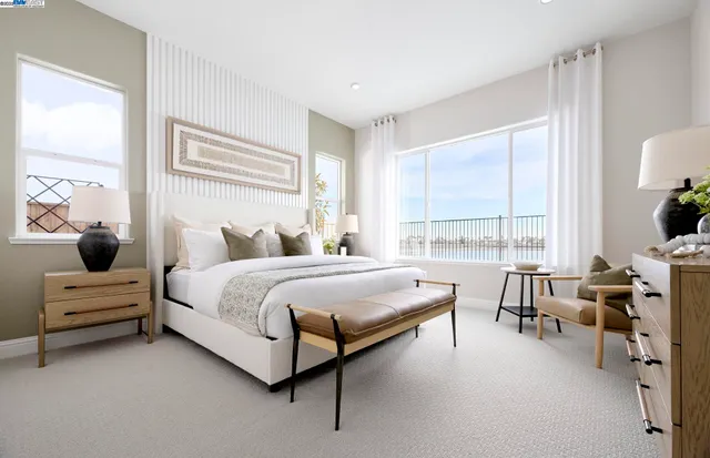 a bedroom with a bed and a large window