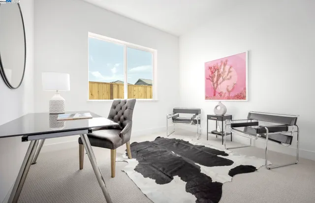 a living room with furniture a window and a potted plant