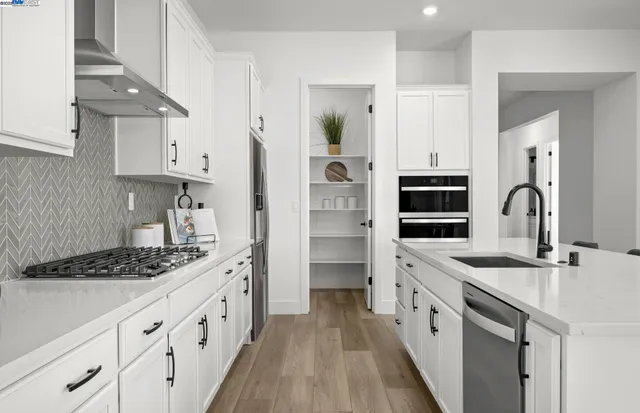 a kitchen with granite countertop a sink stove and cabinets