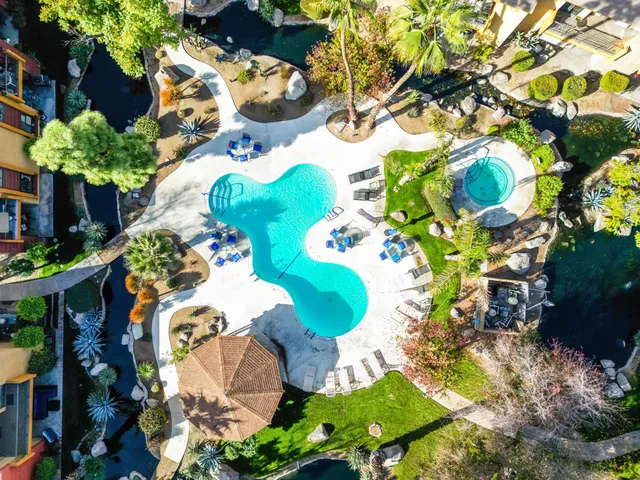 a front view of a house with swimming pool yard and outdoor seating
