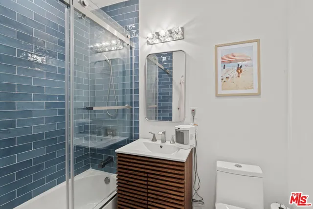a white toilet sitting next to a bathroom sink