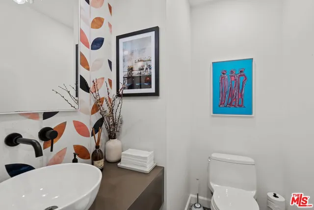 a bathroom with a toilet sink and shower