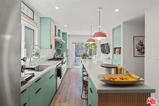 a kitchen with sink and view of living room