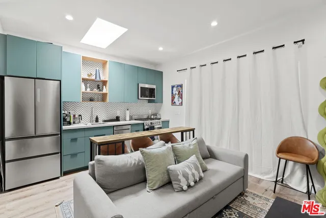 a living room with furniture kitchen and a couch