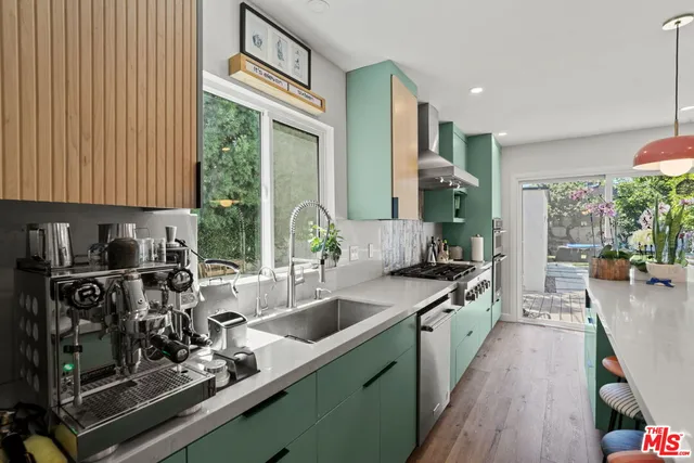 a kitchen with a sink stove and cabinets