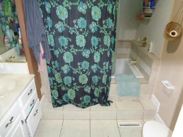 a bathroom with a toilet and shower