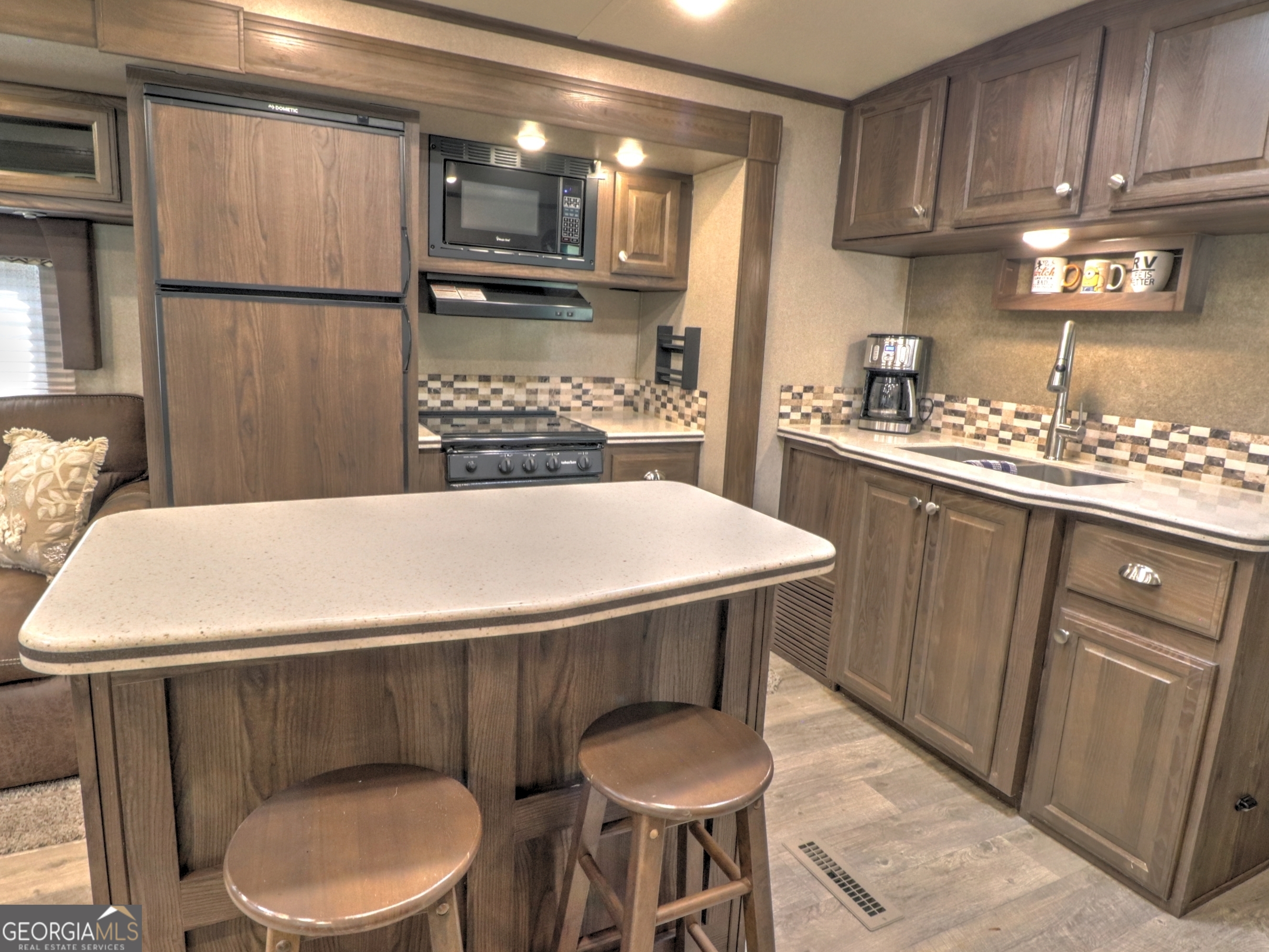 148 Tip Top Circle Cleveland, GA 30528 - Photo 11 of 32 a kitchen with a table chairs sink and cabinets