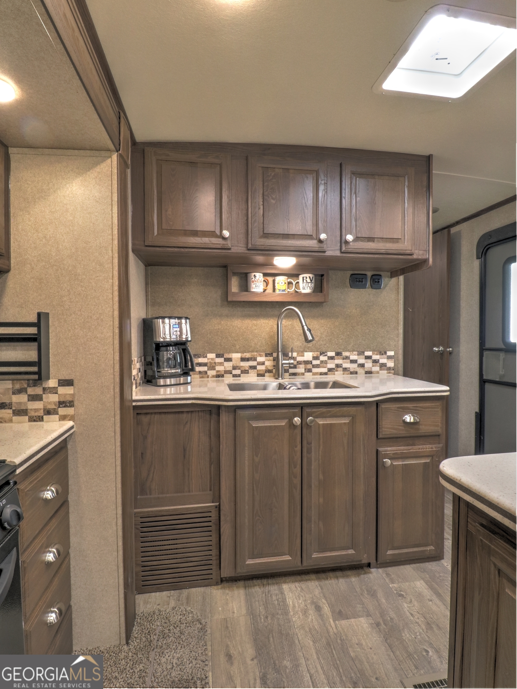 148 Tip Top Circle Cleveland, GA 30528 - Photo 12 of 32 a kitchen with stainless steel appliances granite countertop a refrigerator and a stove top oven