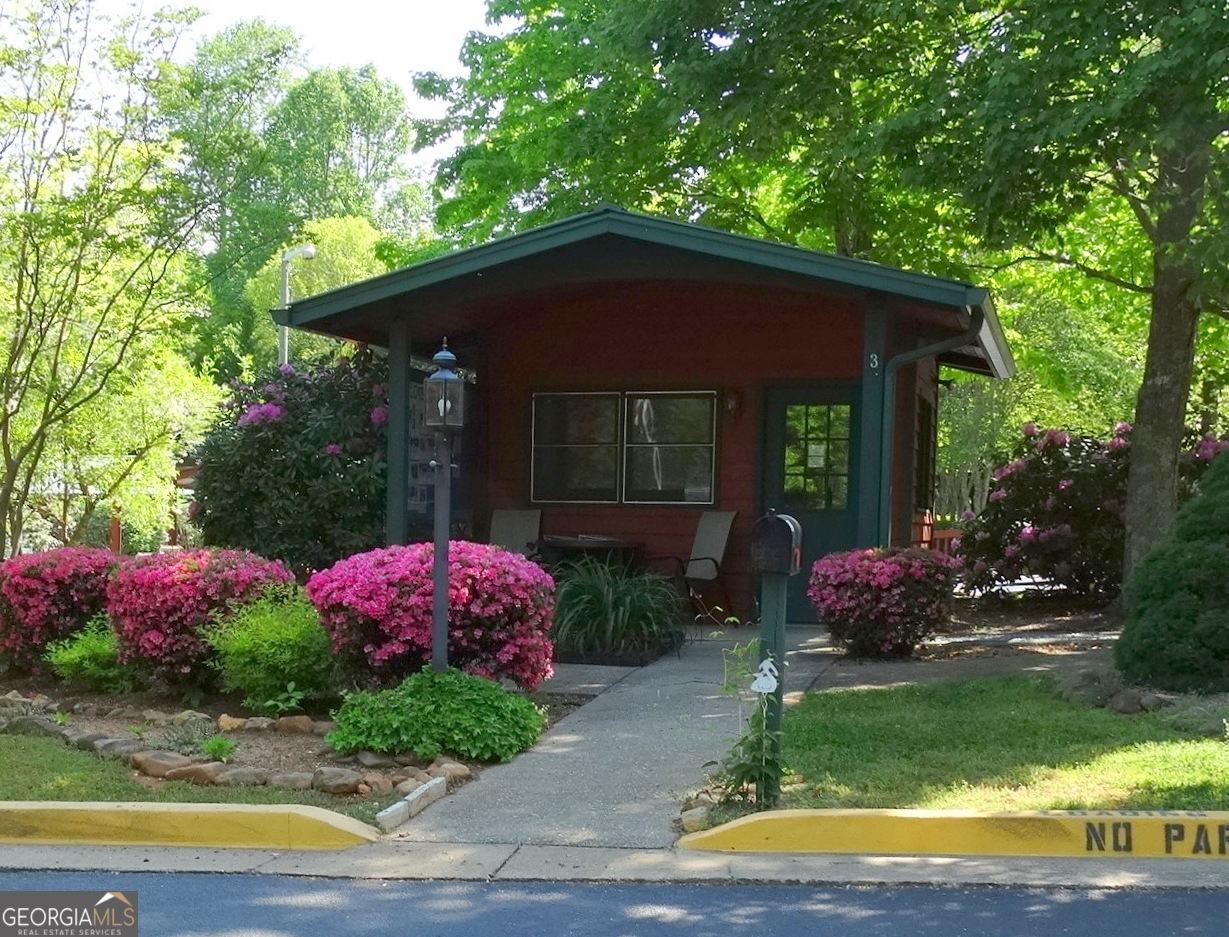 148 Tip Top Circle Cleveland, GA 30528 - Photo 22 of 32 a front view of a house with garden
