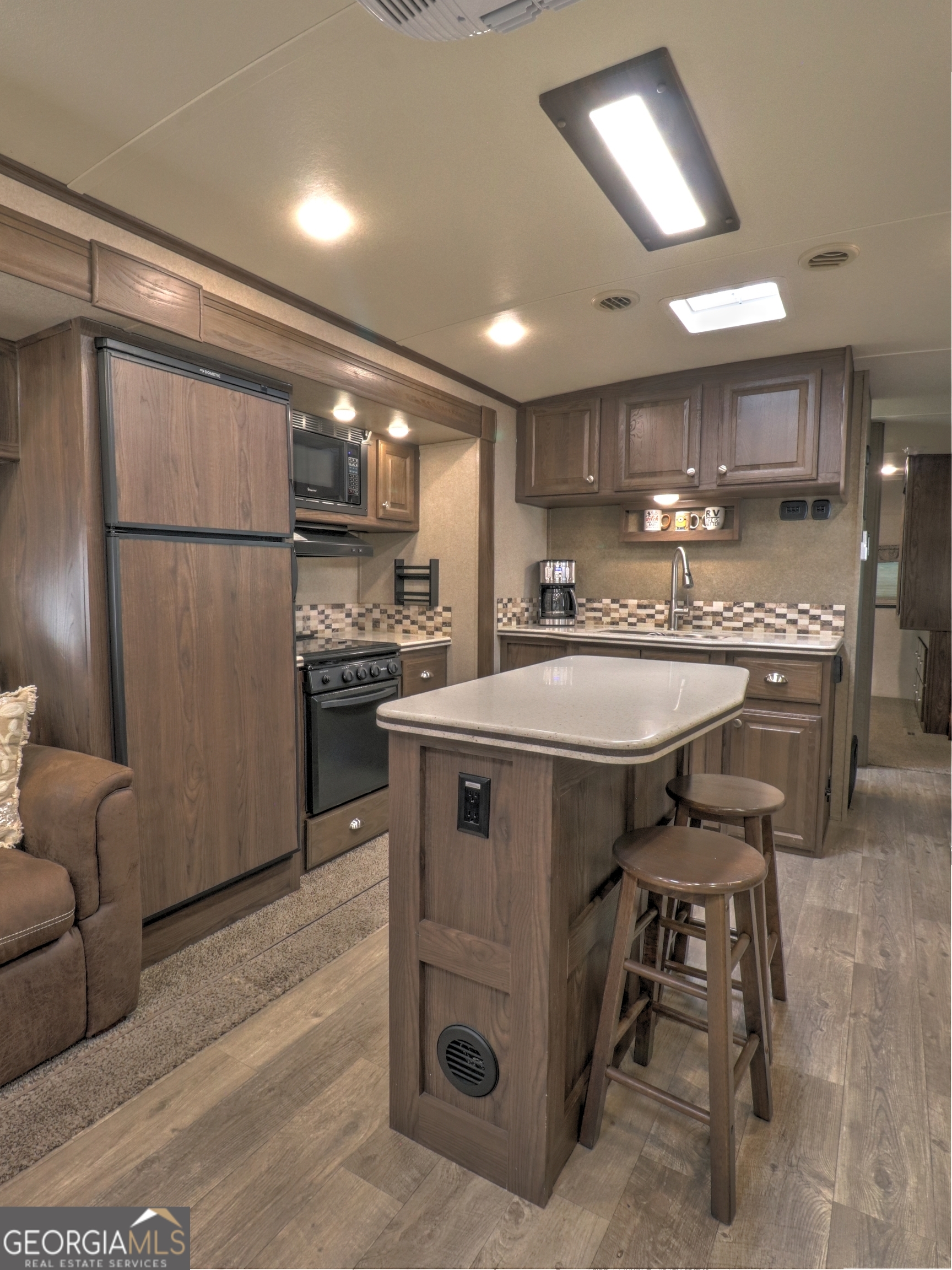148 Tip Top Circle Cleveland, GA 30528 - Photo 10 of 32 a kitchen with kitchen island a sink stove and refrigerator