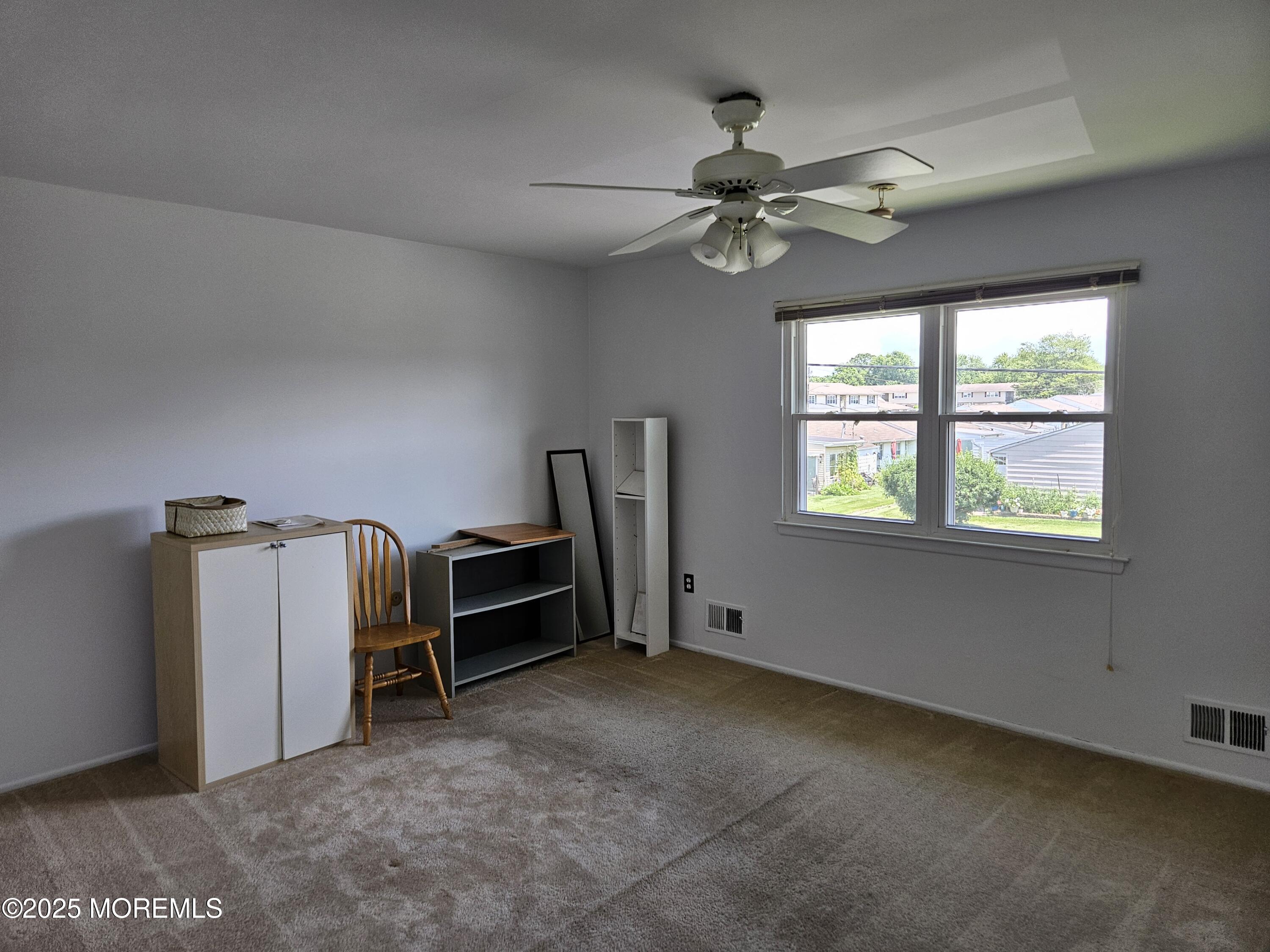 72 Haven Drive, Unit 500 Matawan, NJ 07747 - Photo 6 of 19 a view of a livingroom with a fan