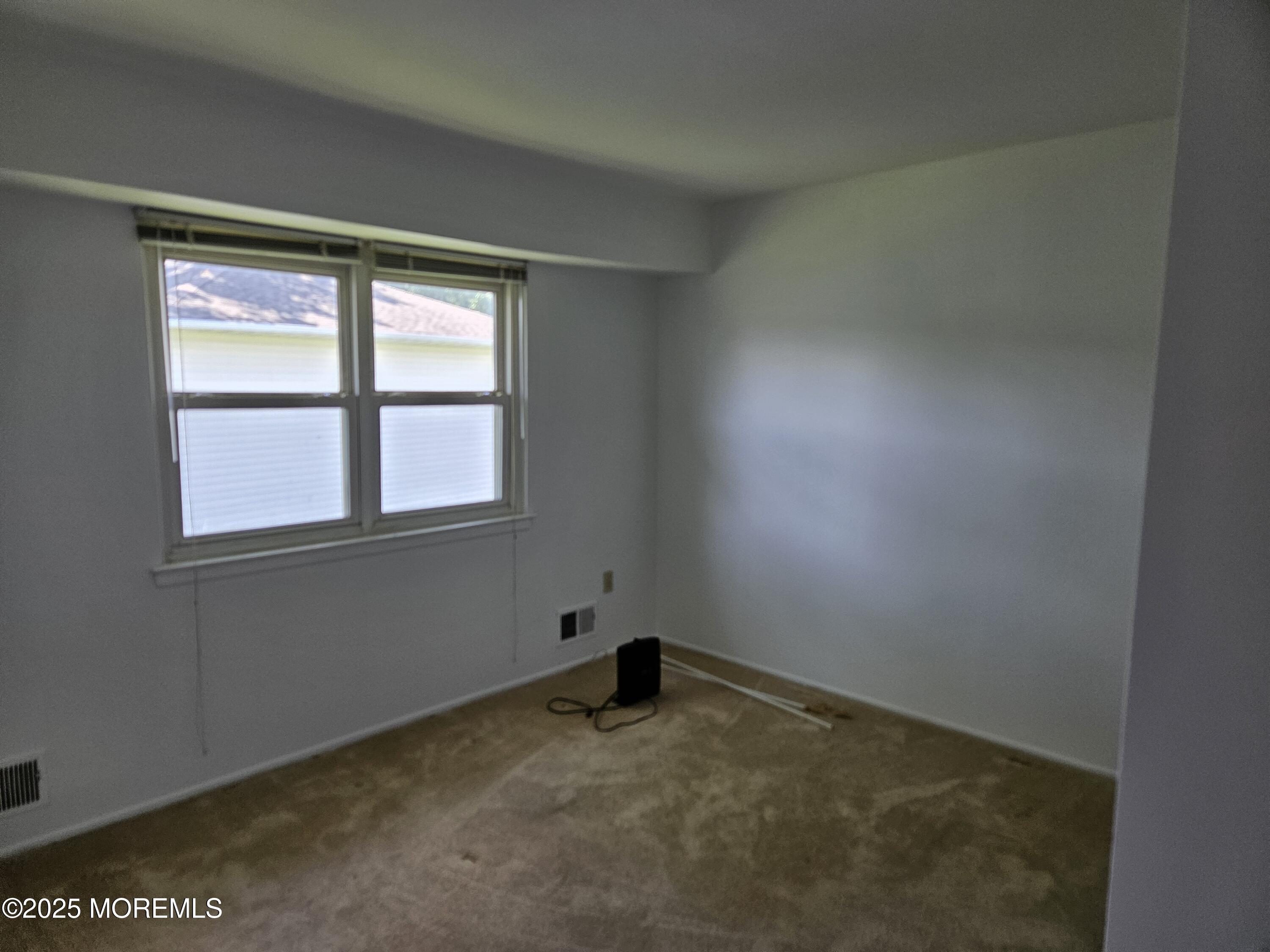 72 Haven Drive, Unit 500 Matawan, NJ 07747 - Photo 7 of 19 a view of an empty room with a window