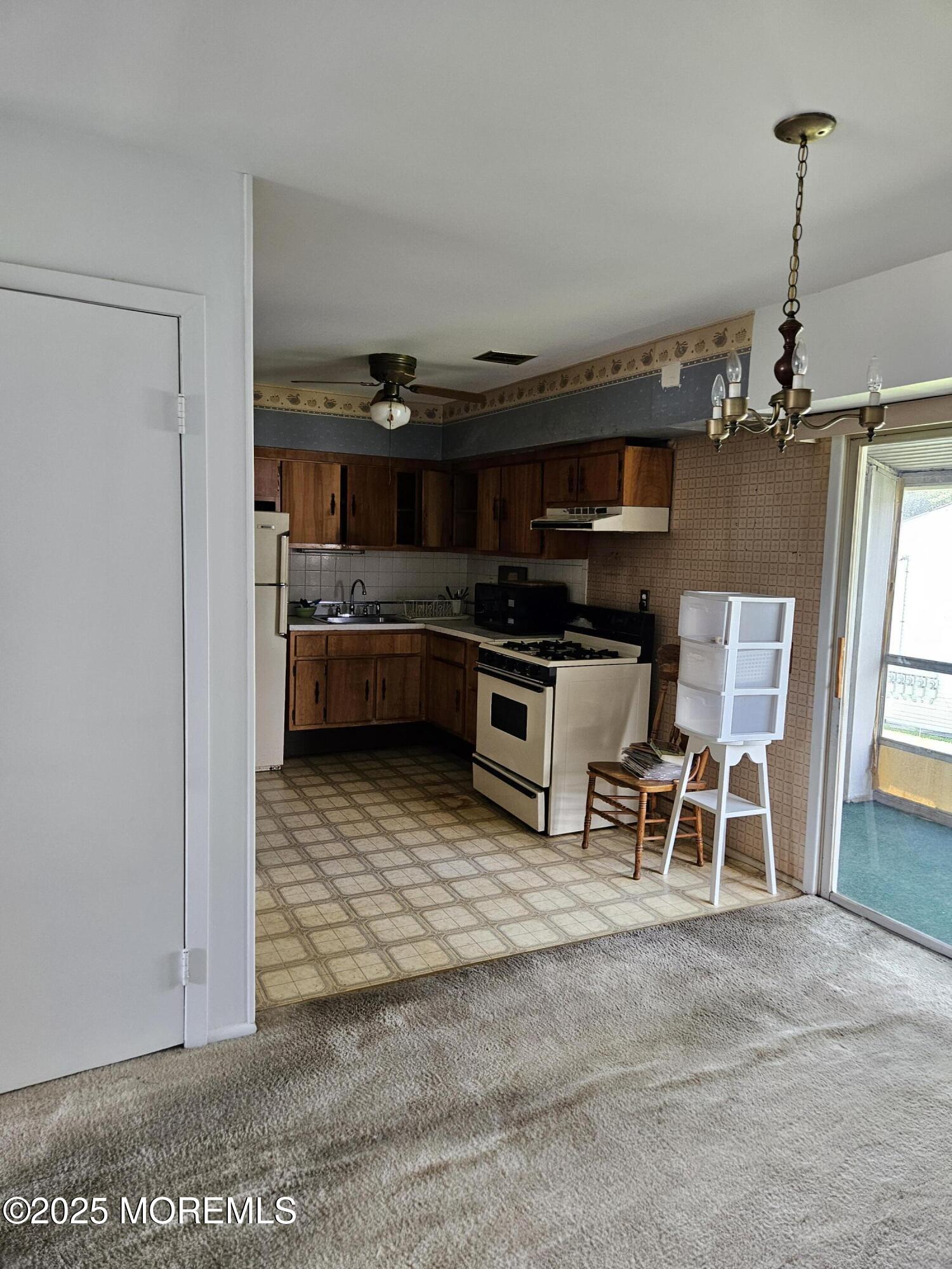 72 Haven Drive, Unit 500 Matawan, NJ 07747 - Photo 8 of 19 a living room with stainless steel appliances kitchen island granite countertop furniture and a fireplace