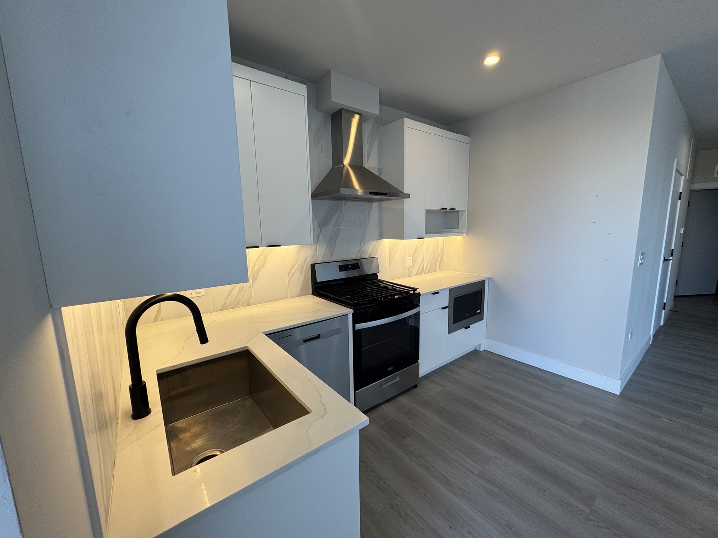 503 East Pershing Road, Unit 301 Chicago, IL 60653 - Photo 8 of 21 a kitchen with stainless steel appliances granite countertop a stove a sink and a microwave