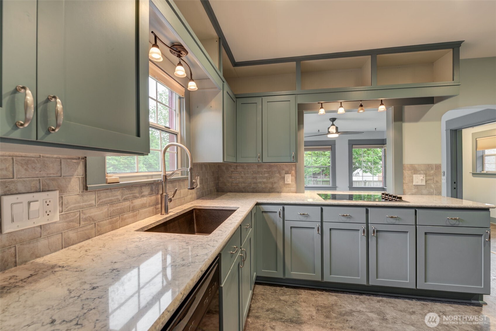 654 West Main Street Monroe, WA 98272 - Photo 12 of 40 a kitchen with a sink stove and cabinets