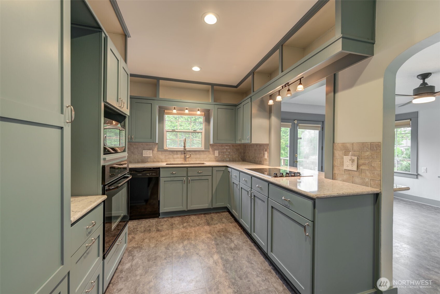 654 West Main Street Monroe, WA 98272 - Photo 14 of 40 a large kitchen with granite countertop a stove and a sink