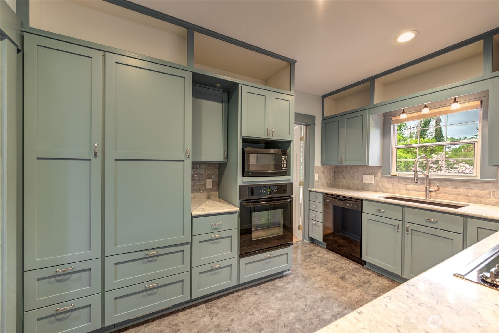 654 West Main Street Monroe, WA 98272 - Photo 15 of 40 a kitchen with a refrigerator and a sink