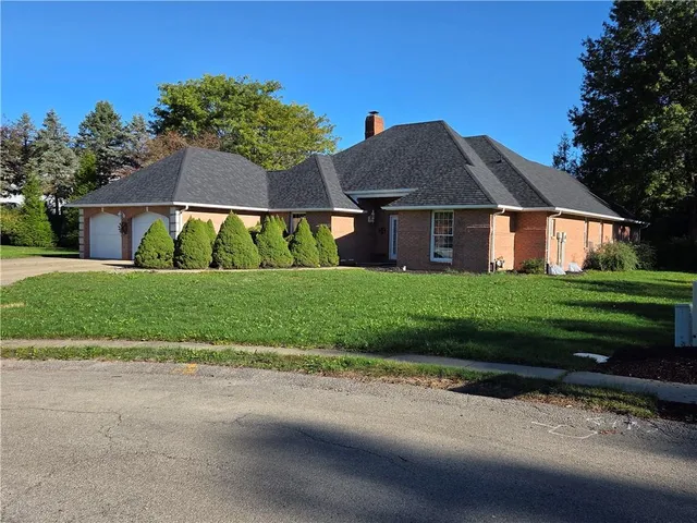 a front view of house with yard and green space