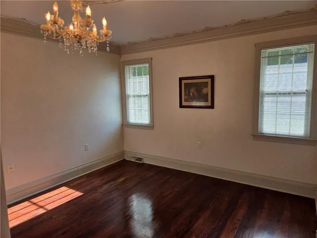 a view of a room with windows and a chandelier fan