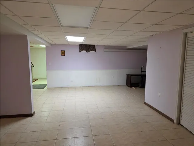 an empty room with chandelier fan