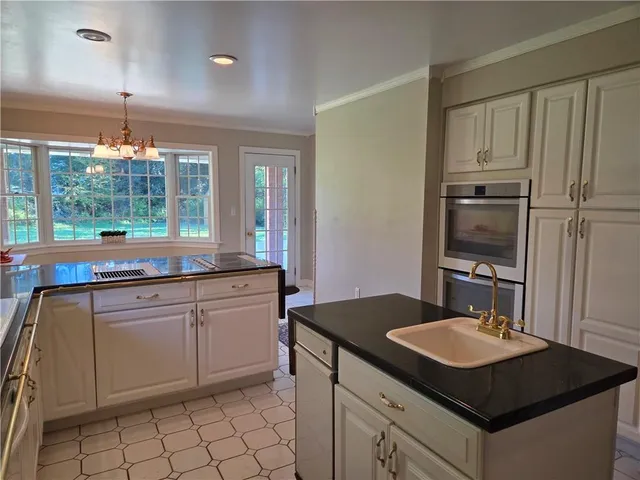 a kitchen with a sink stove and cabinets