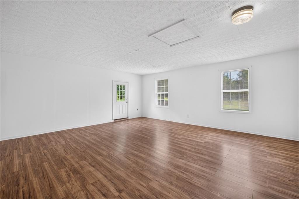 602 Pendergrass Road Winder, GA 30680 - Photo 34 of 44 an empty room with wooden floor and windows