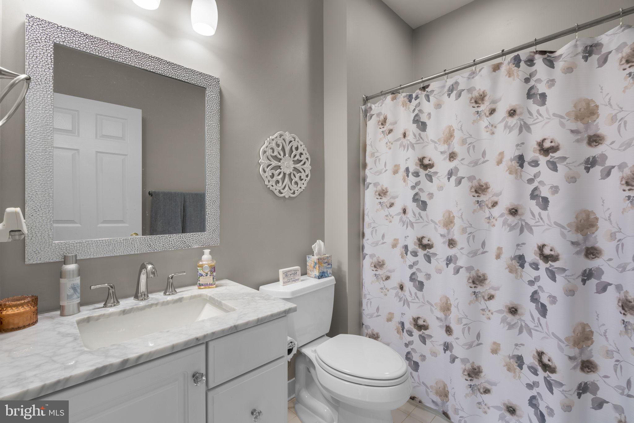 4617 Brightwood Road Olney, MD 20832 - Photo 24 of 58 a bathroom with a granite countertop sink and a toilet