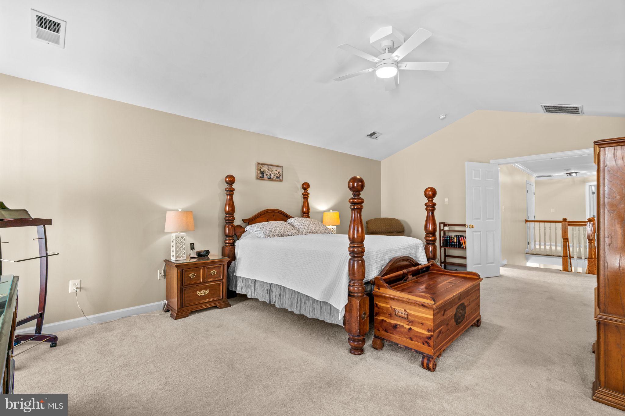 4617 Brightwood Road Olney, MD 20832 - Photo 26 of 58 a bed room with a bed and a chandelier