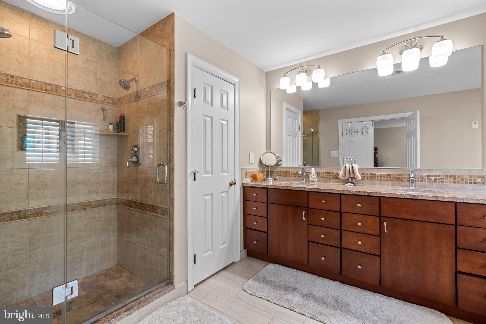 4617 Brightwood Road Olney, MD 20832 - Photo 29 of 58 a bathroom with a shower sink and mirror