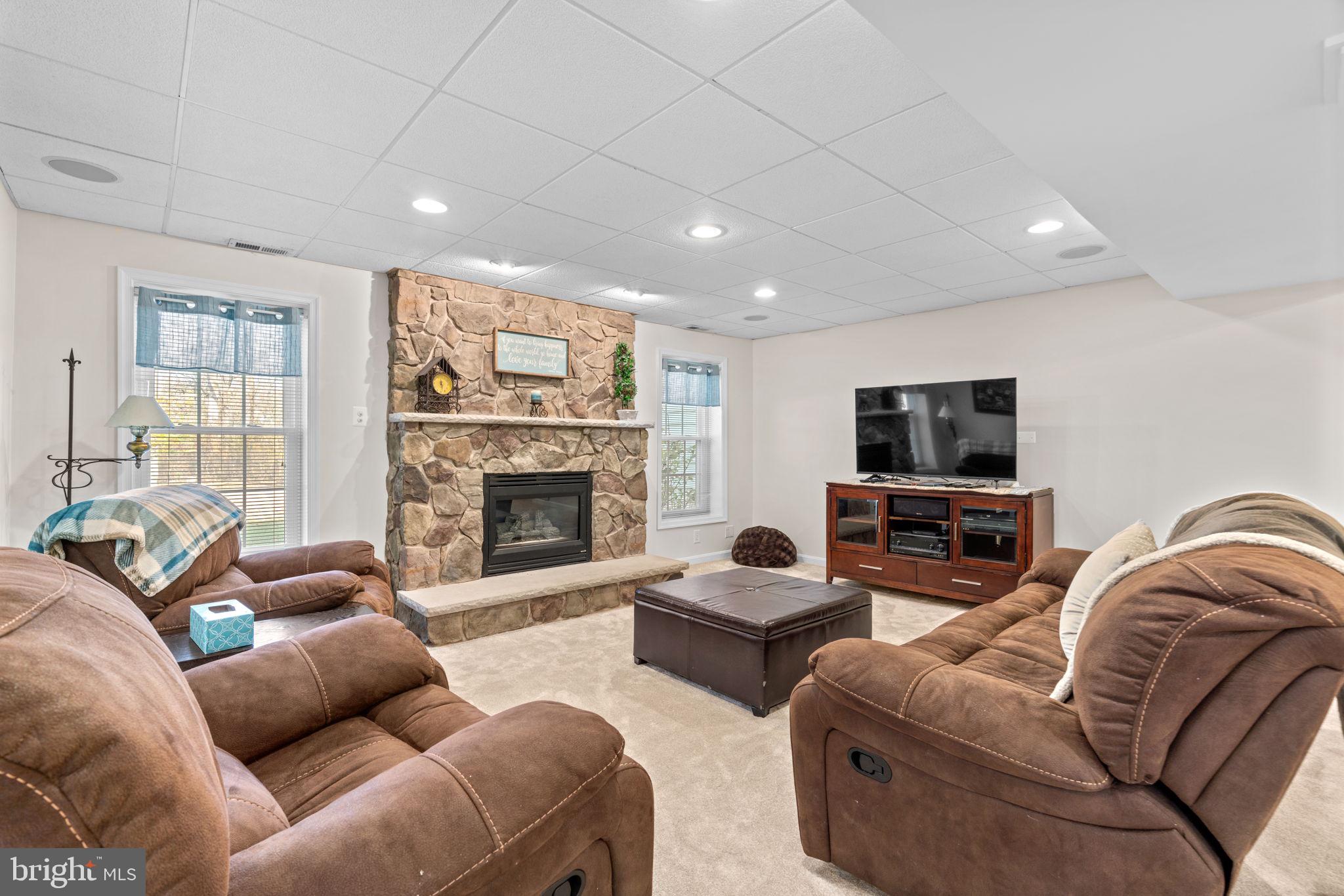 4617 Brightwood Road Olney, MD 20832 - Photo 39 of 58 a living room with furniture fireplace and a flat screen tv