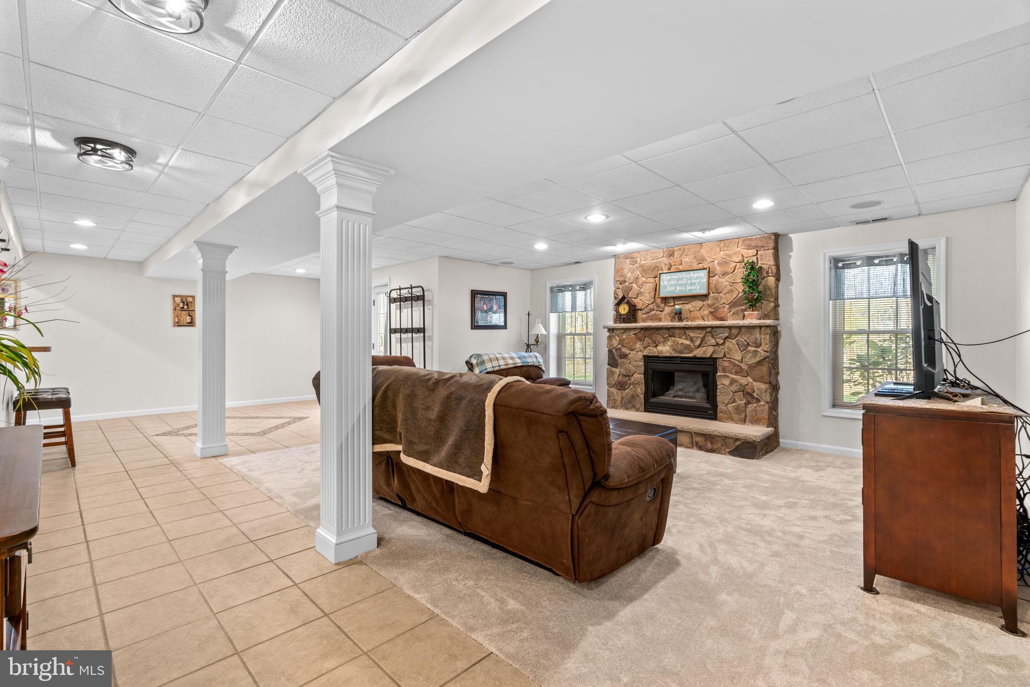 4617 Brightwood Road Olney, MD 20832 - Photo 41 of 58 a living room with furniture and a fireplace