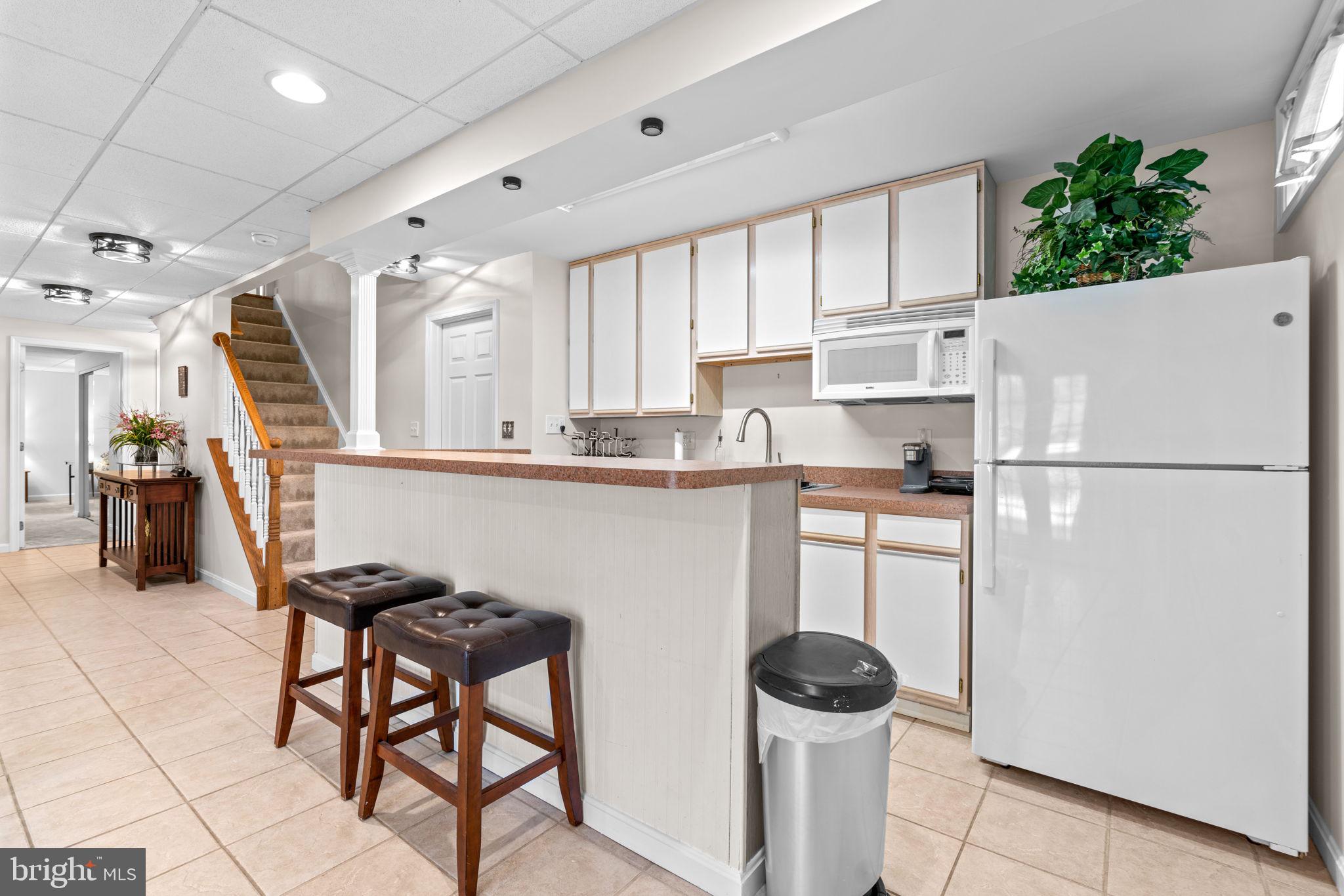 4617 Brightwood Road Olney, MD 20832 - Photo 44 of 58 a kitchen with stainless steel appliances granite countertop a refrigerator and a stove top oven