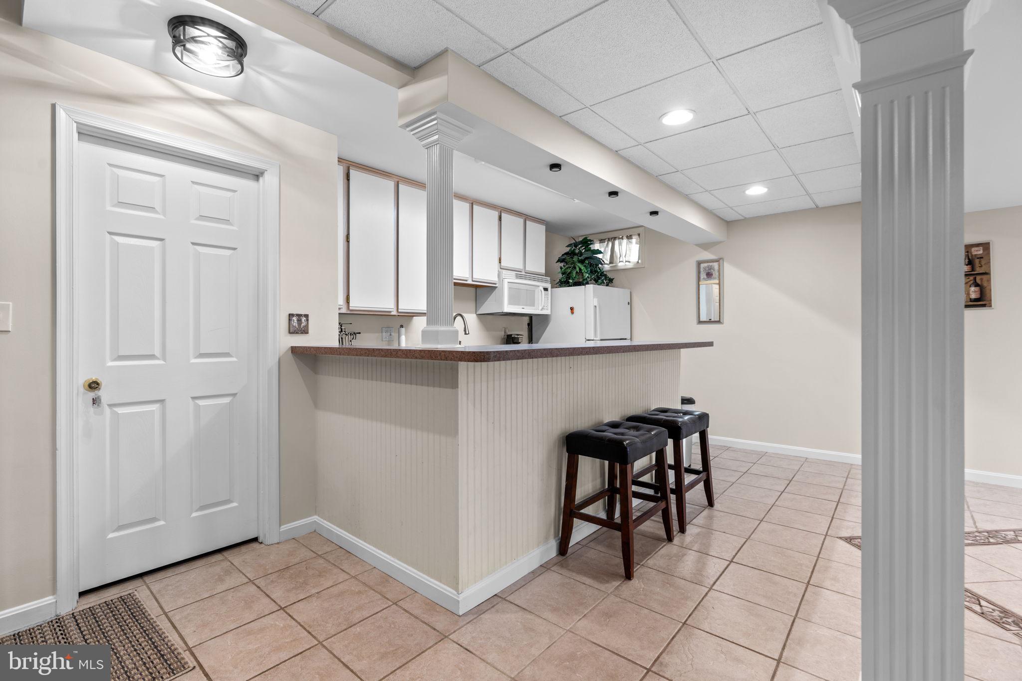 4617 Brightwood Road Olney, MD 20832 - Photo 46 of 58 a kitchen with stainless steel appliances granite countertop a sink and a refrigerator