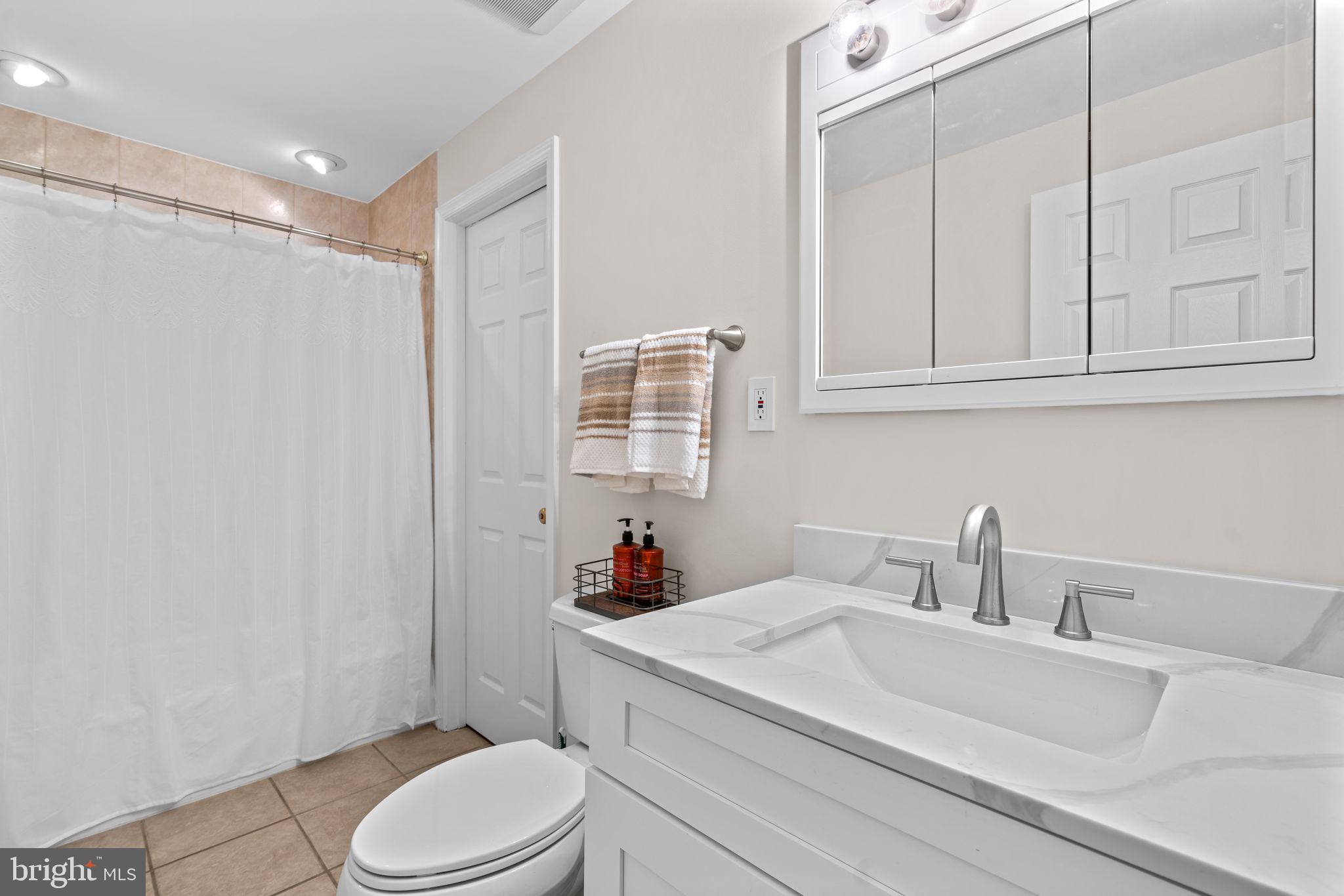 4617 Brightwood Road Olney, MD 20832 - Photo 47 of 58 a bathroom with a sink toilet vanity and tub