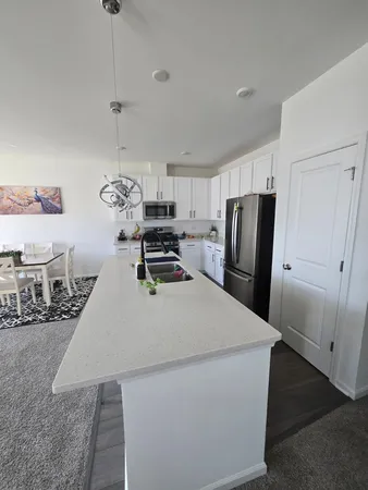 a kitchen with stainless steel appliances a refrigerator sink and wooden cabinets