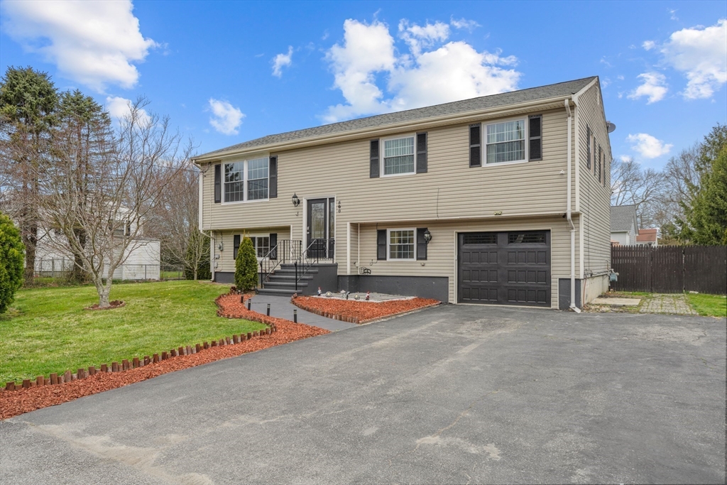 a front view of a house with a yard and garage